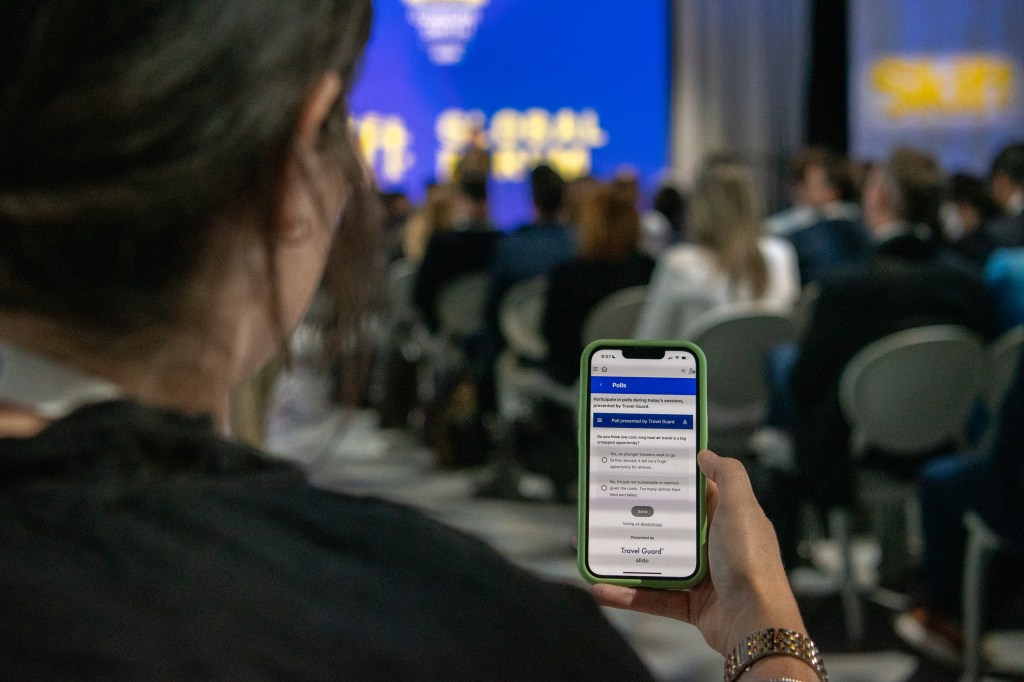 an attendee using the Skift Live app at Skift Global Forum